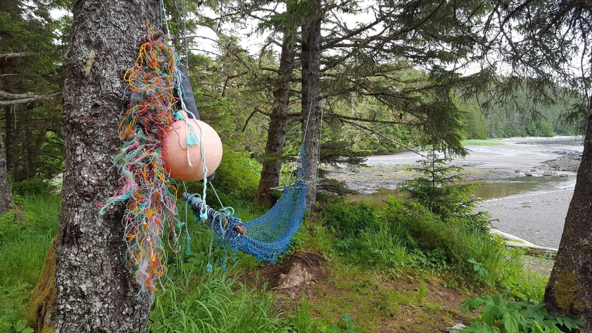 Colorful fishing buoy and hammock hanging in the Tongass rainforest