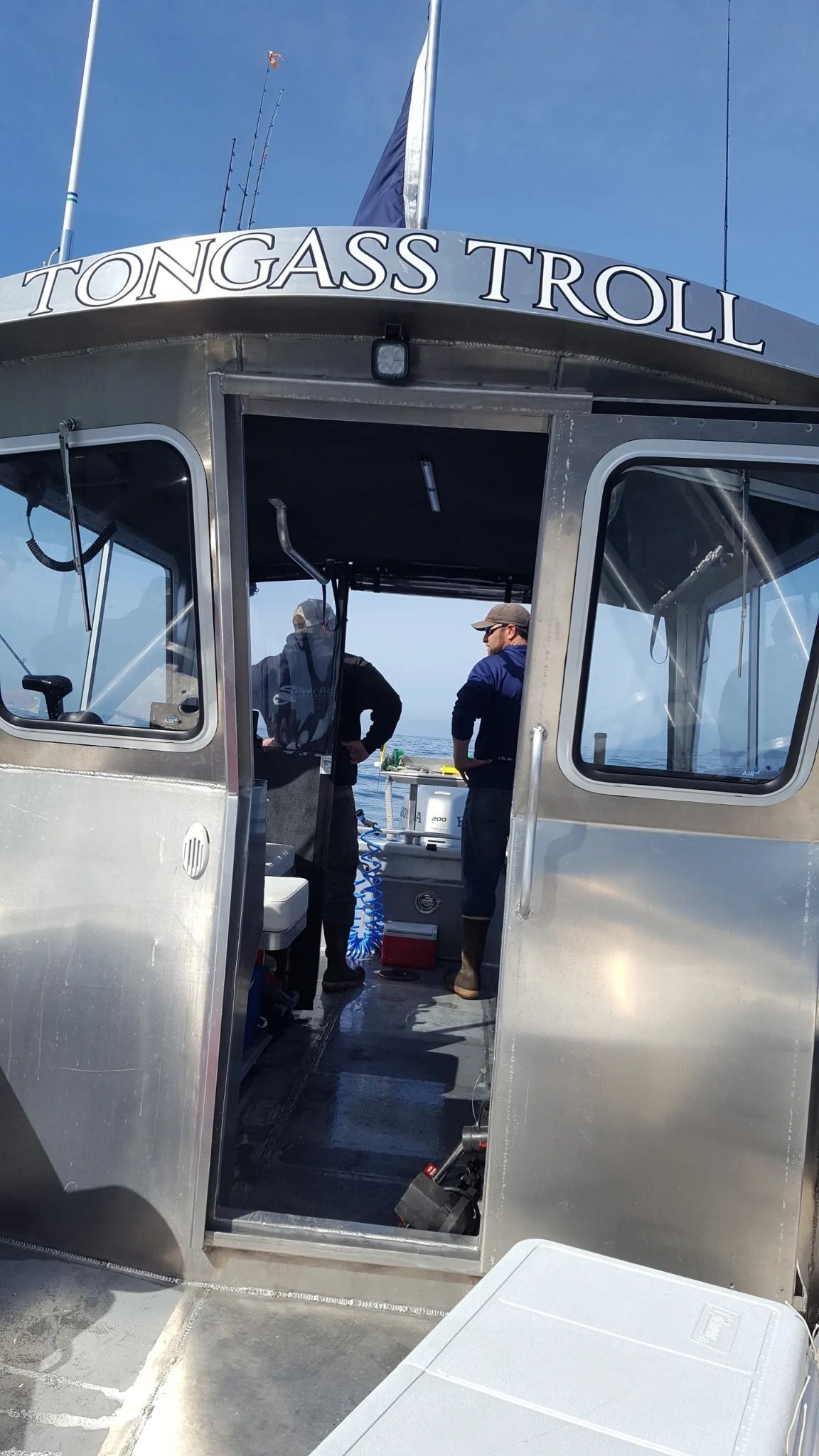 Guests aboard the Tongass Troll watching for wildlife through the cabin windows