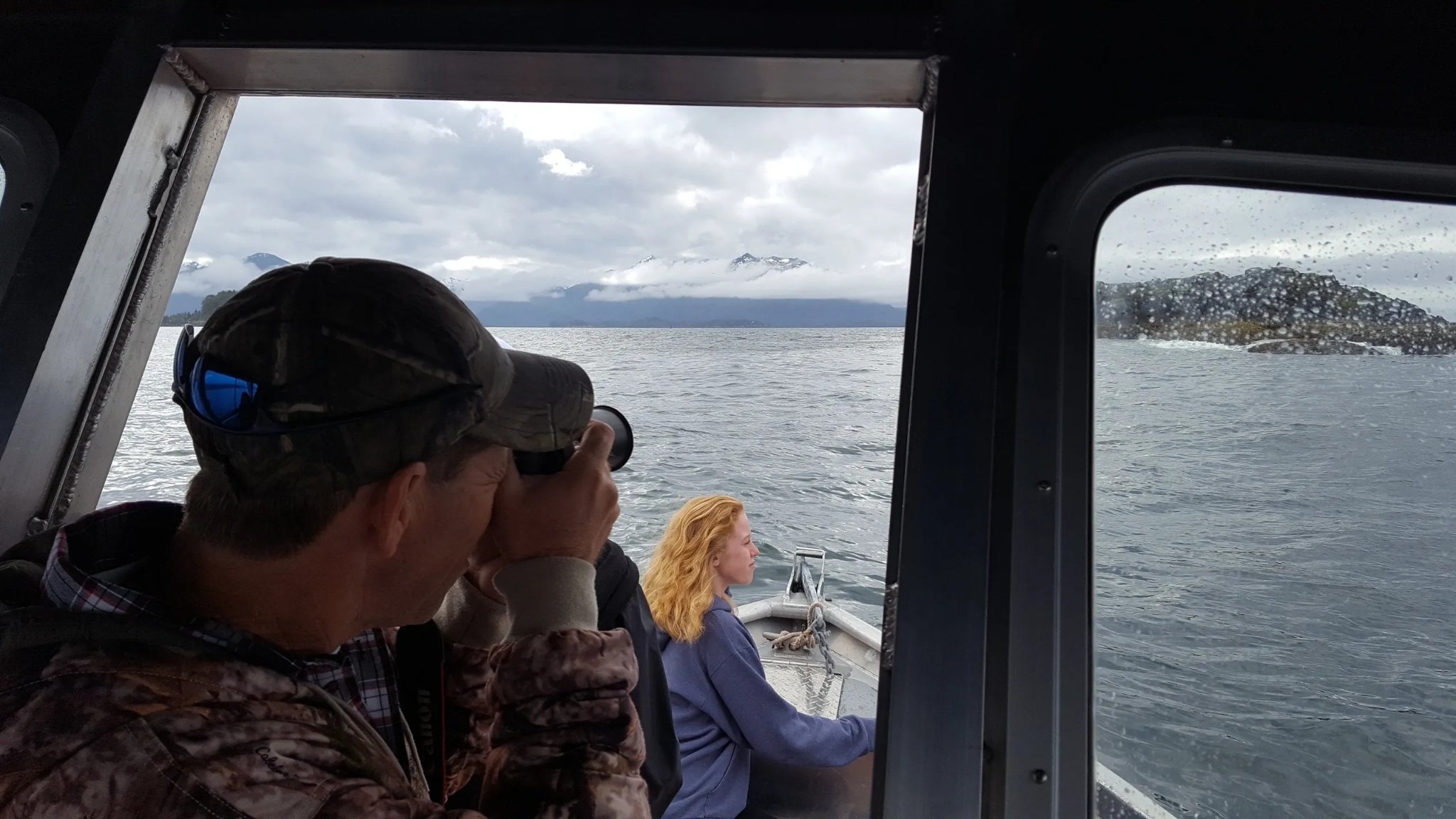 The Tongass Troll aluminum boat on its trailer with snow-capped mountains behind